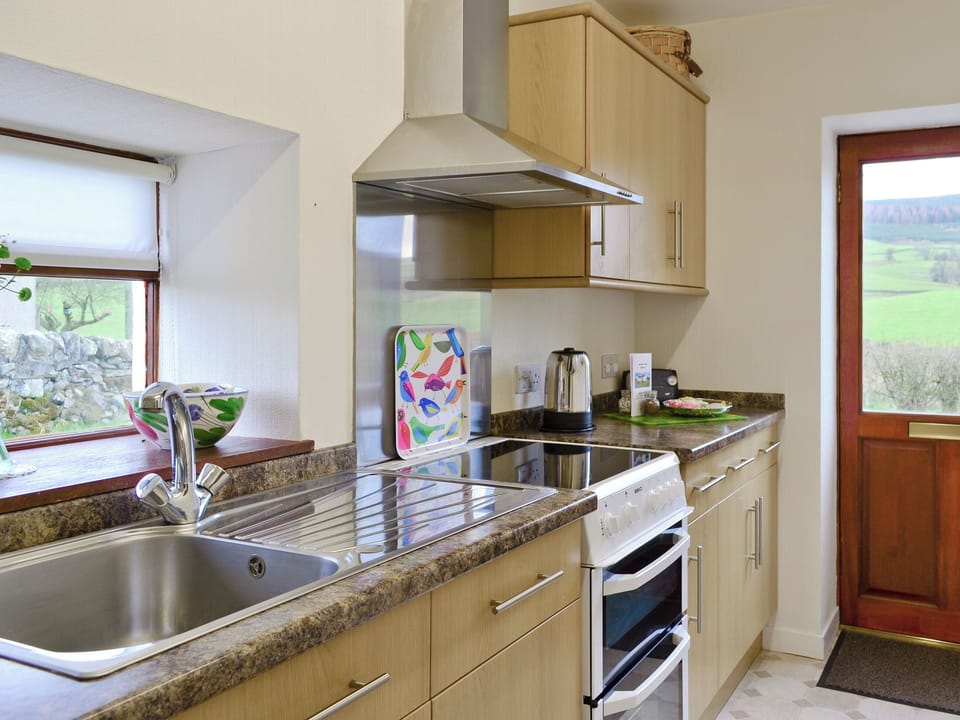 Well-equipped &lsquo;galley-style&rsquo; kitchen | Beuchan Cottage - Beuchan Farm, Keir Mill, Thornhill
