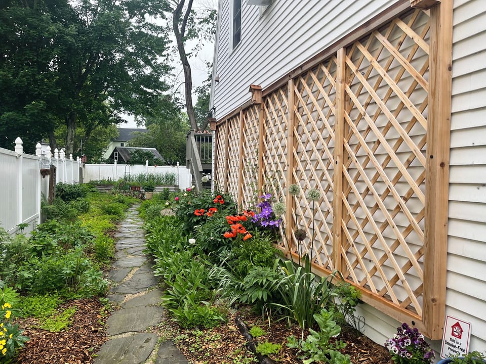 Side garden leads to apartment entrance