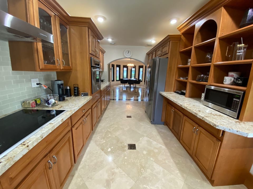 Kitchen fully equipped leading to dining room