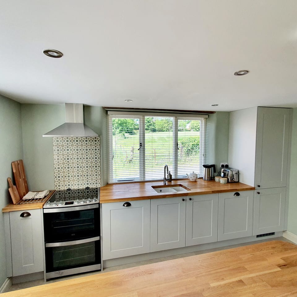 Kitchen with oven, microwave, fridge freezer, dishwasher.