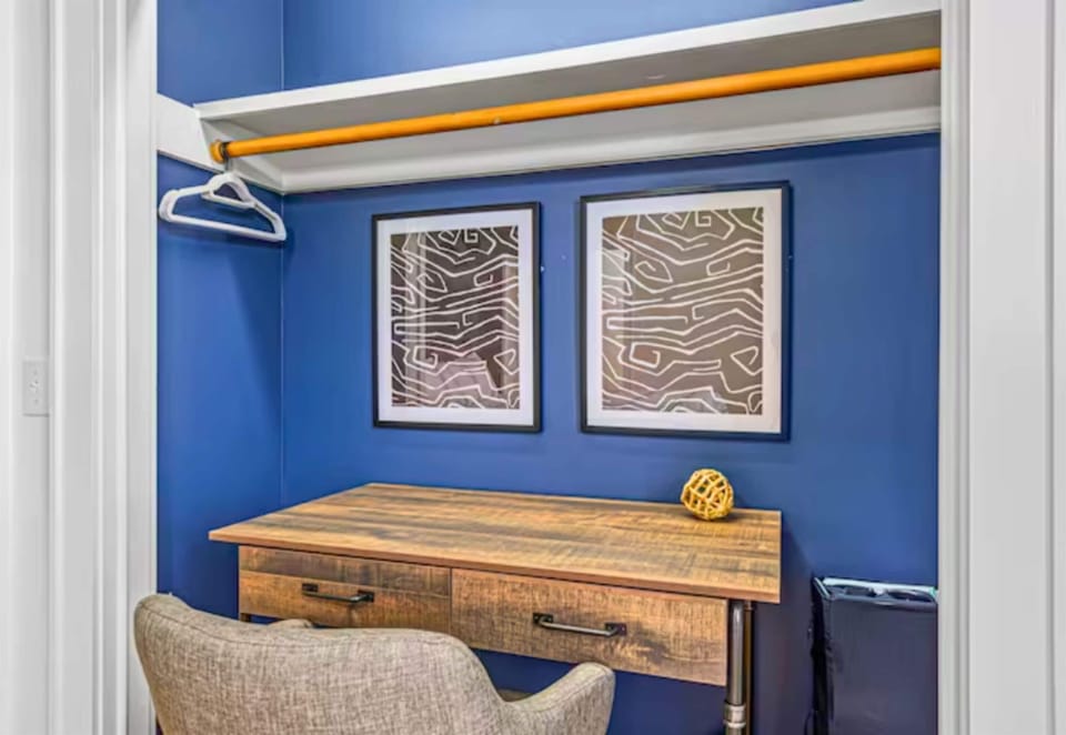 Dedicated Workspace in the Third Bedroom with Wood Desk and Chair