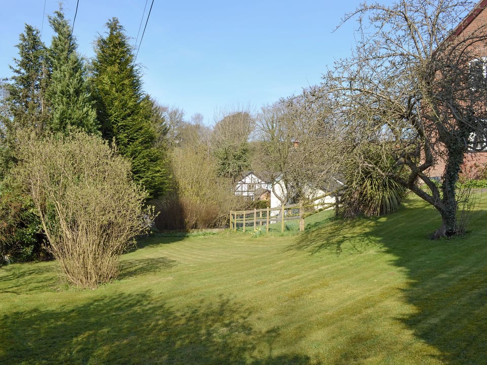 Well-maintained lawned garden area | Swallows Barn Cottage - Colley Mill Farm, North Rode