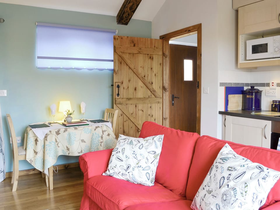 Convenient dining area and exposed carved wooden beams | Shepherdskirk - Wide Sky Cottages, Lowick, near Berwick-on-Tweed