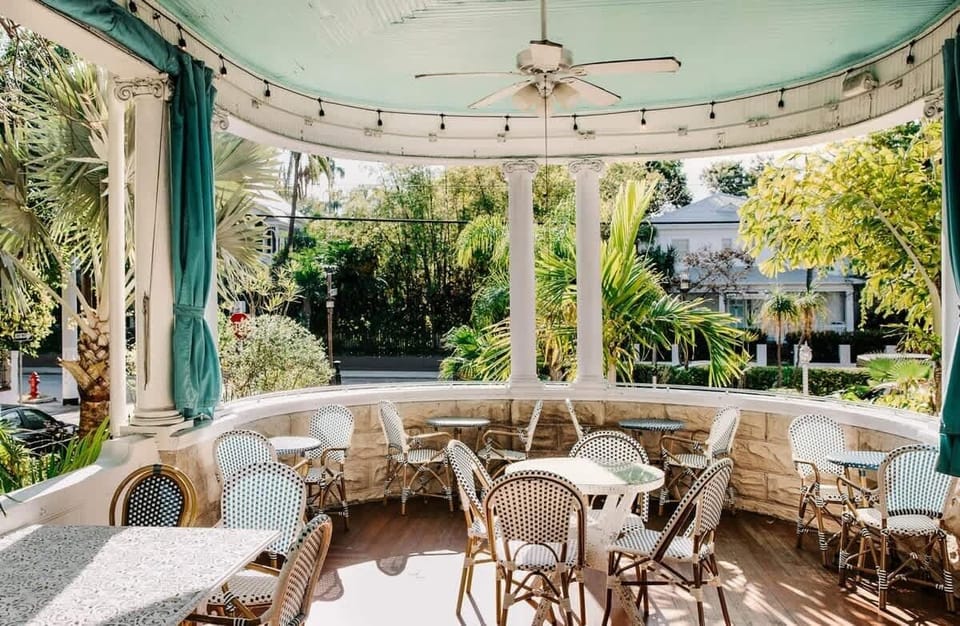 Enjoy or your morning coffee on the grand wrap around porch of the Curry Mansion. With Views of Caroline street and lush local foliage.