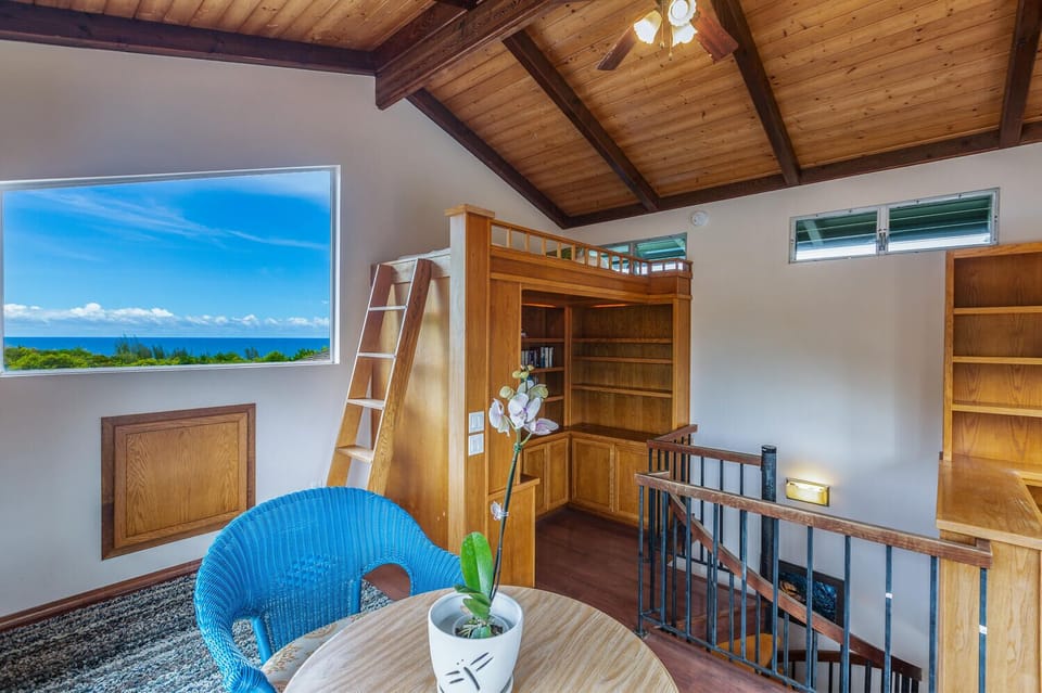 Up the spiral staircase, discover a charming loft bedroom with twin bed and play area, perfect for kids or teens.
