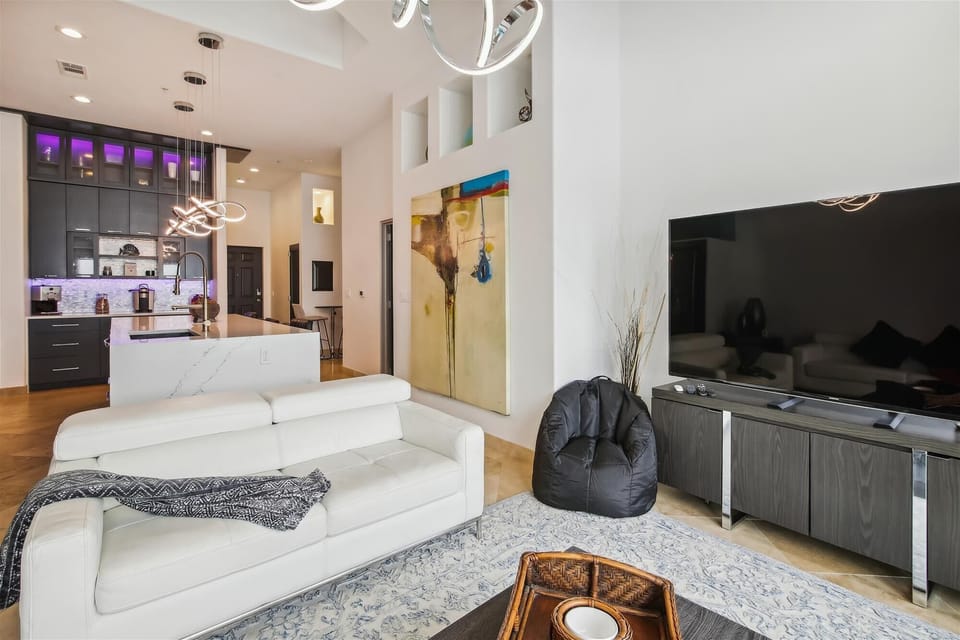 Artistic Design - Gorgeous art, fun lighting and a chic palette lend to the luxurious atmosphere of this penthouse condo.