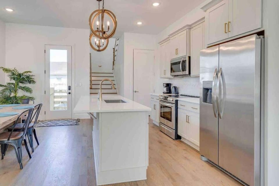 Kitchen: Sleek appliances and bright light for inspired cooking.