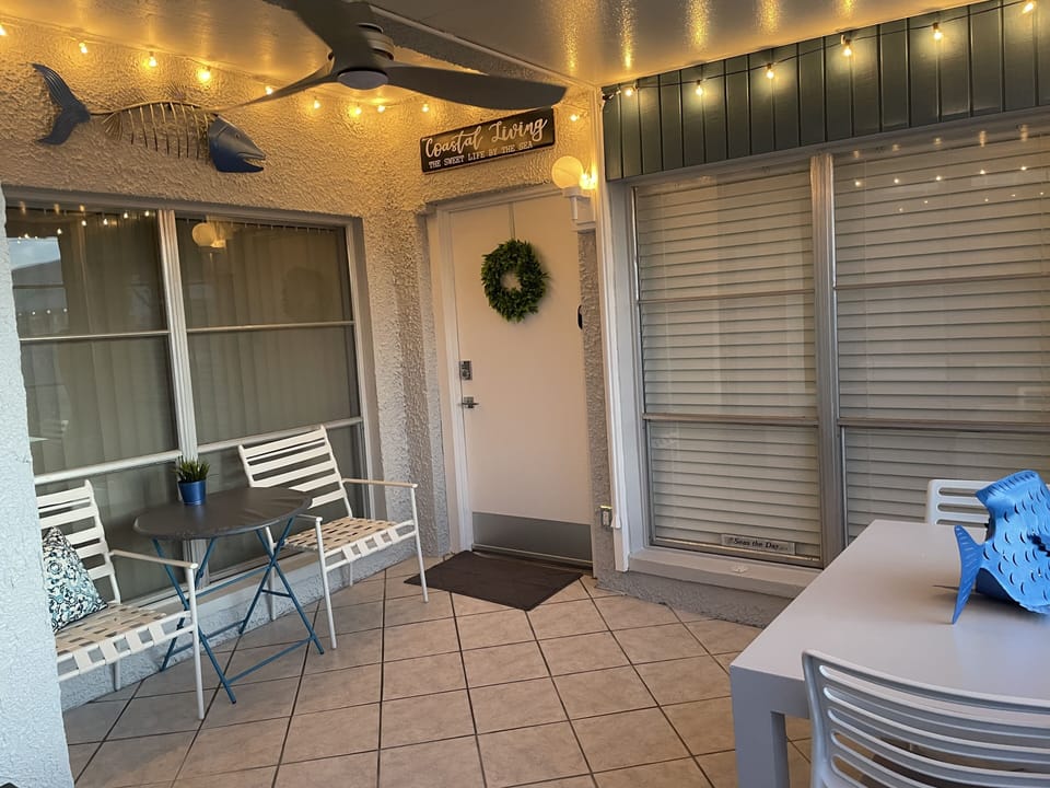 Lanai in evening with lights, plenty of room and larger dining table