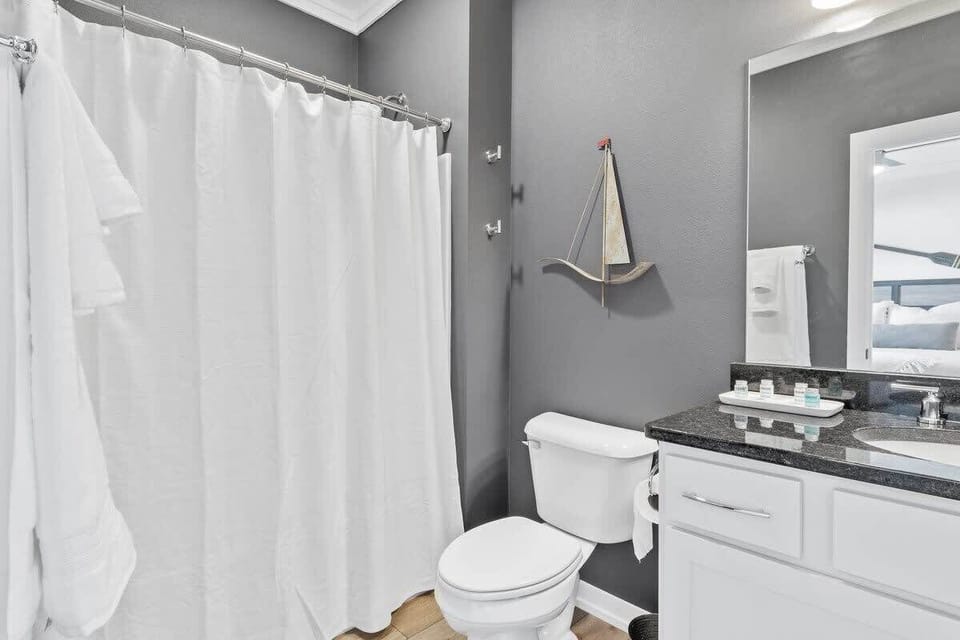 Bright master bathroom with a walk-in shower, white vanity, modern fixtures, and clean contemporary finishes.
