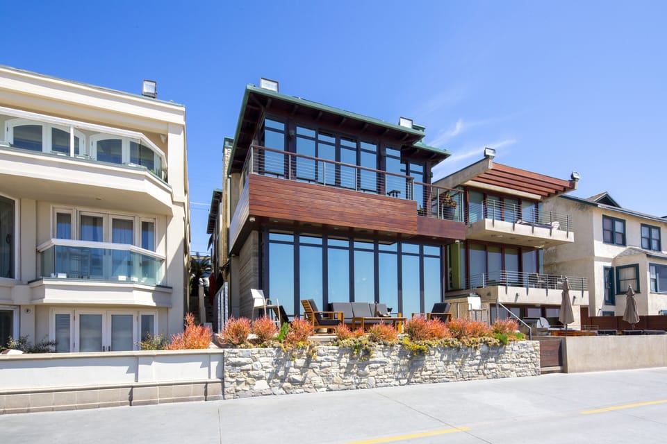 Beach front sliding doors that disappear to a large Deck w/ firepit & furniture.