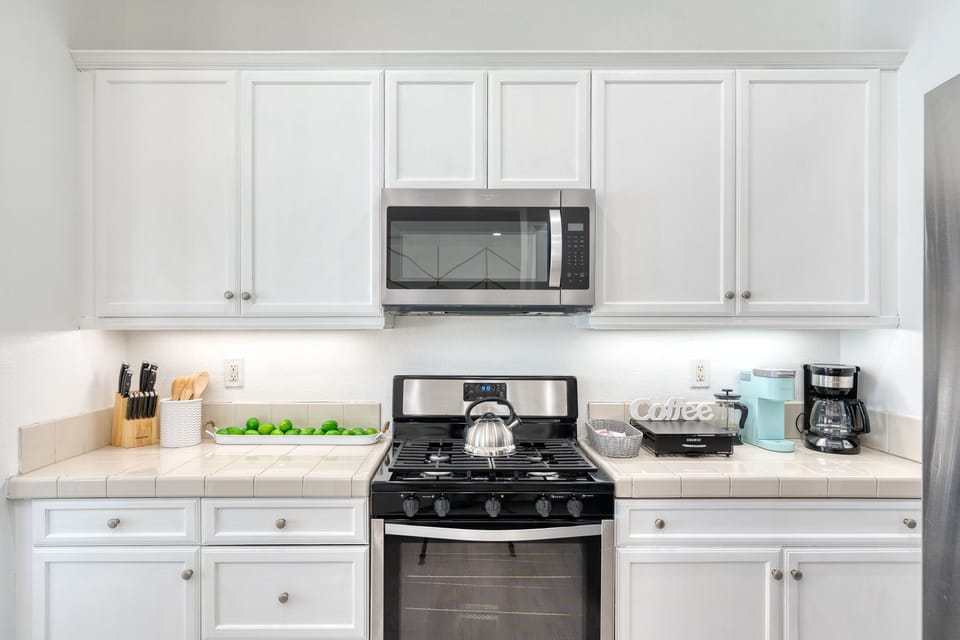Crisp white kitchen to make your favorite meal in the fully stocked kitchen 
