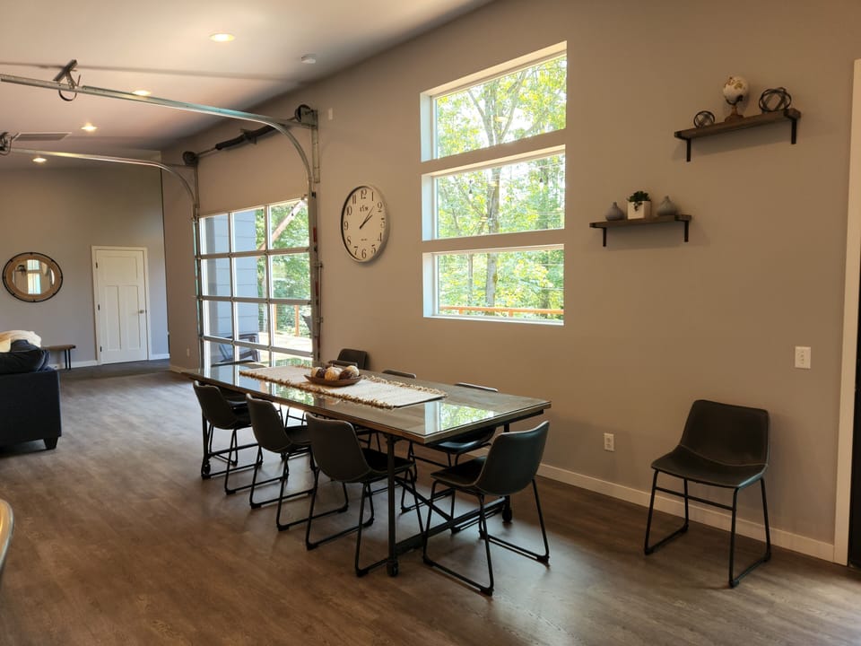Large dining area with adjacent garage door that opens to the deck
