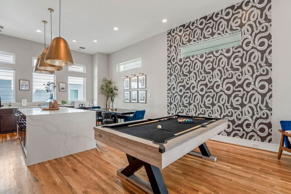 Perfect for entertaining! Large pool table featuring custom snake photo wall.