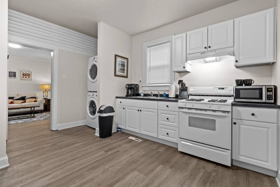 Fully stocked kitchen, laundry and view of the living room