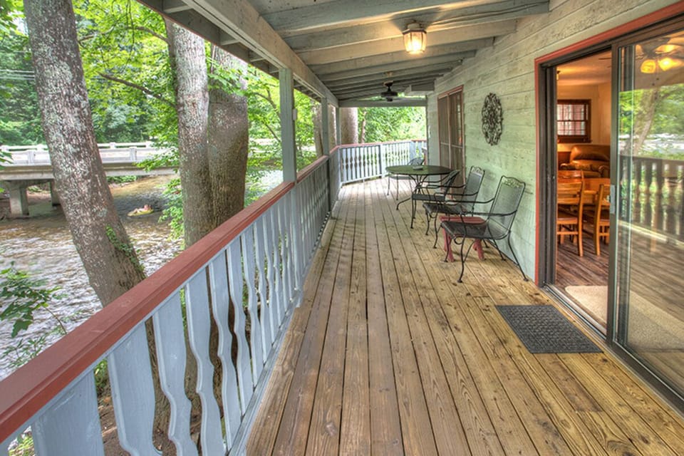Covered back porch with outdoor seating just outside the kitchen area
