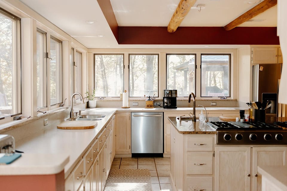 Large kitchen with panoramic views of woods and lake
