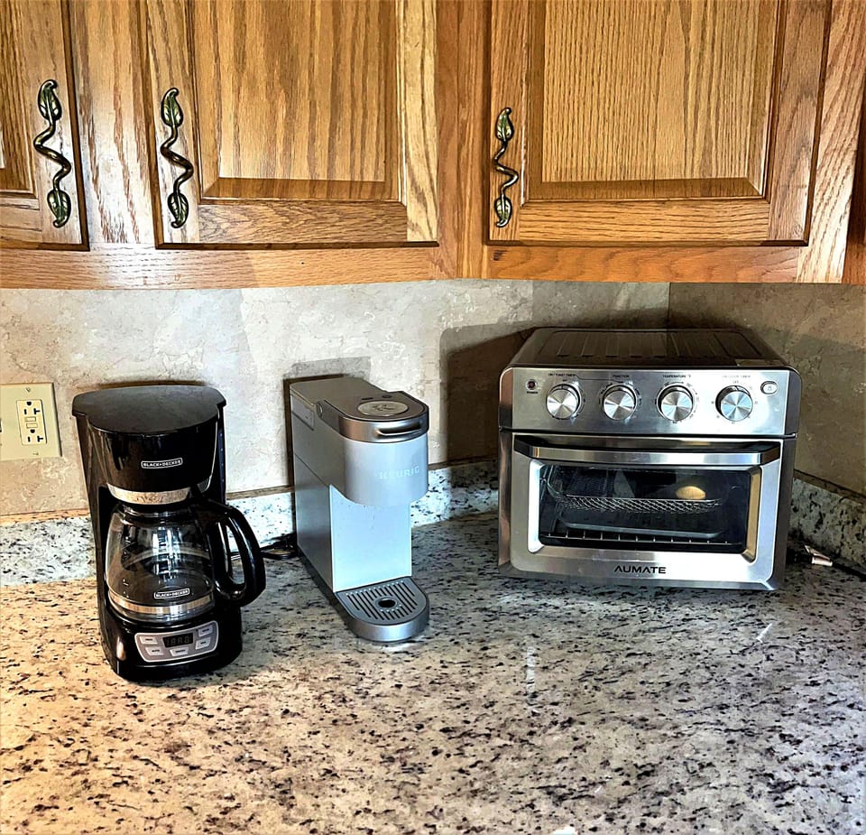 The kitchen has a combination bread toaster/oven, drip style coffee maker, and a Keurig coffee maker.