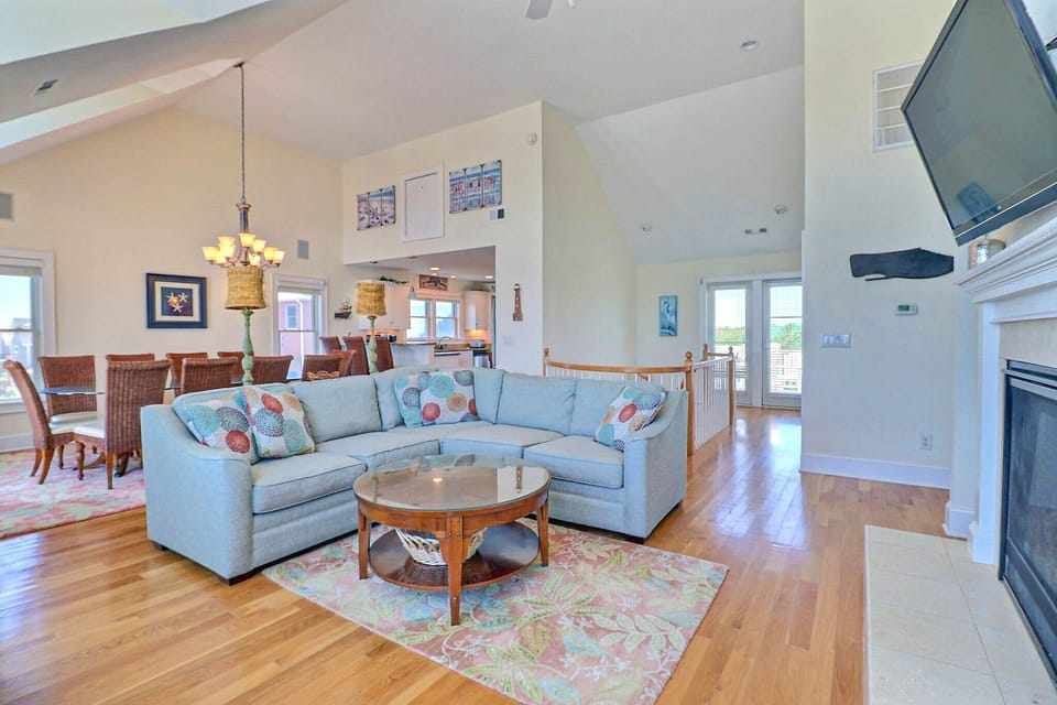 In the central living area, turn on the gas fireplace and enjoy movie night on the comfy couch or simply relax and bask in the sunshine as it filters in through several large windows.