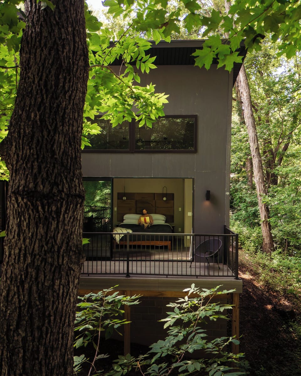 Open the glass wall and let the forest become part of the bedroom.