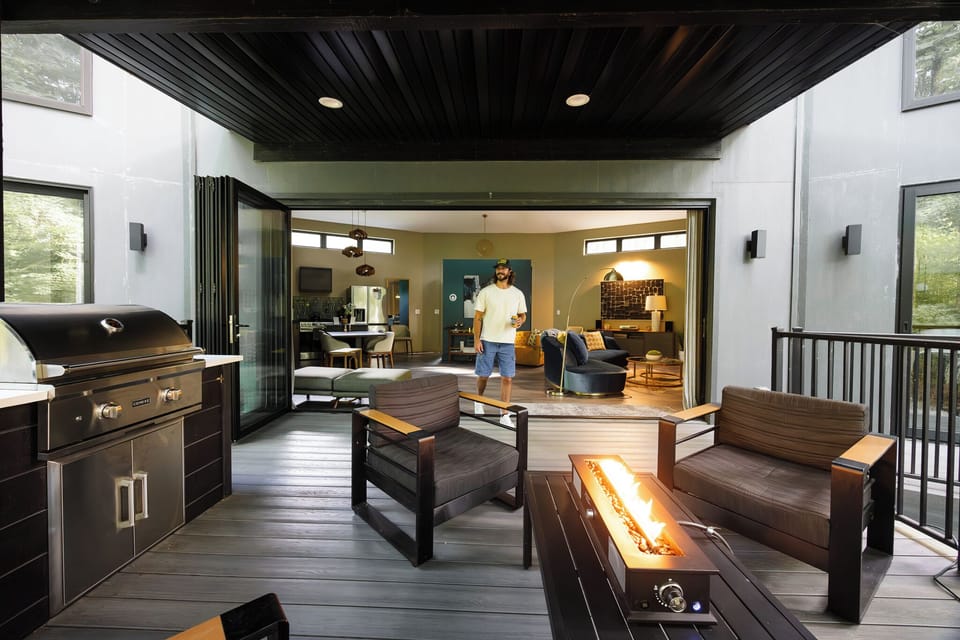 Indoor-outdoor living with an accordion glass wall that opens to the forest.