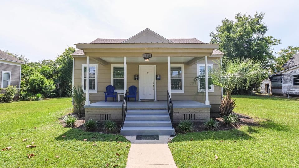 Exterior of Unit A. Relax on the front porch with two adirondack chairs.
