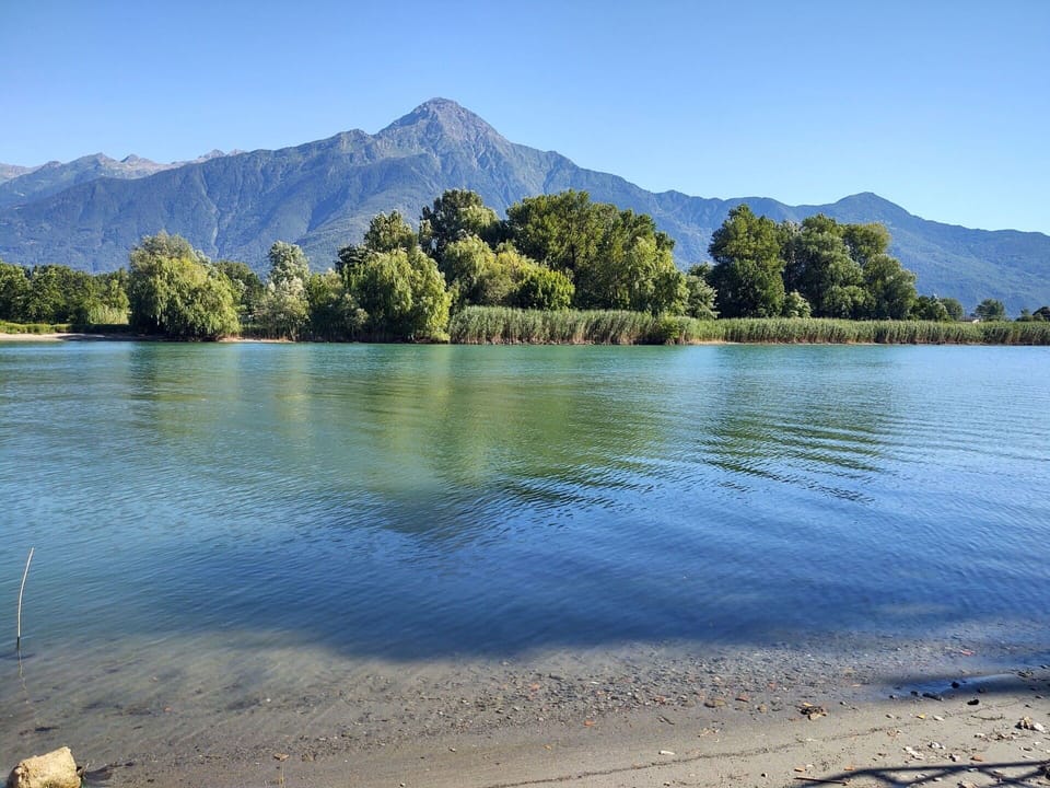 Water, Sky, Mountain, Ecoregion, Azure, Natural Landscape, Tree, Natural Environment, Lake, Coastal And Oceanic Landforms
