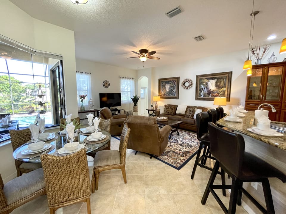 Open-plan living area with plush seating and elegant dining set, perfect for relaxation or entertaining.