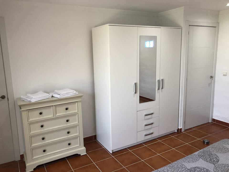Bedroom one with en-suite wardrobe and chest of draws.