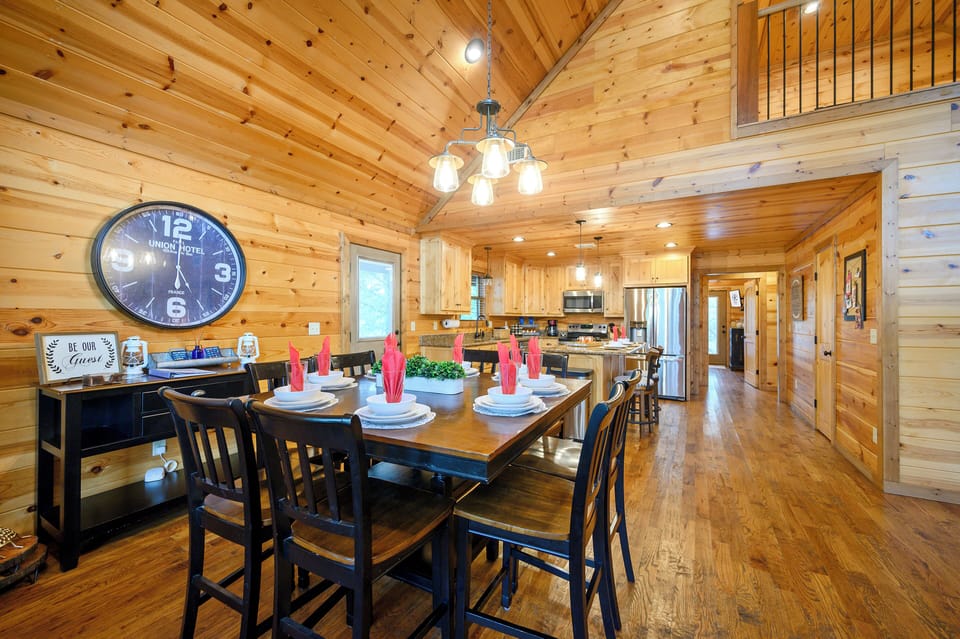 Gather around your spacious dining table under soaring cathedral ceilings in this warm, knotty pine cabin. The fully equipped kitchen stands ready for your culinary adventures.
