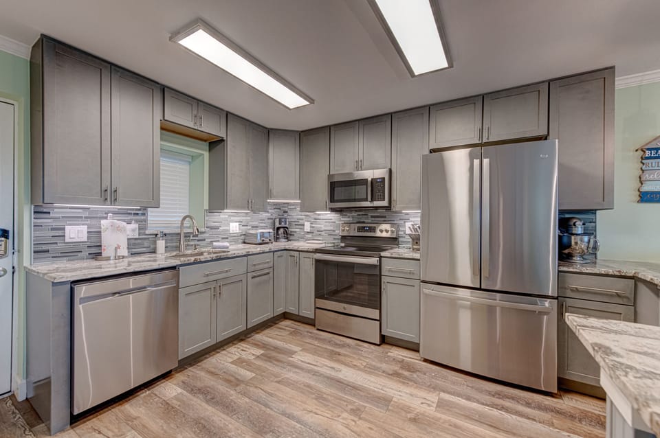 Your gourmet kitchen awaits with granite counters, stainless appliances, and skylights that bathe your culinary adventures in natural light.