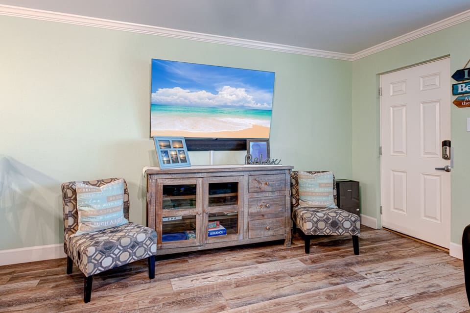 Unwind in your coastal-themed entertainment space with comfortable seating and beach views that transport you to paradise.