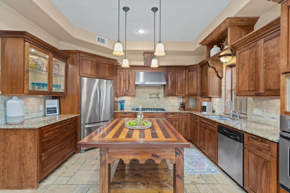 Custom Hand Carved Cabinetry and Stainless appliances
