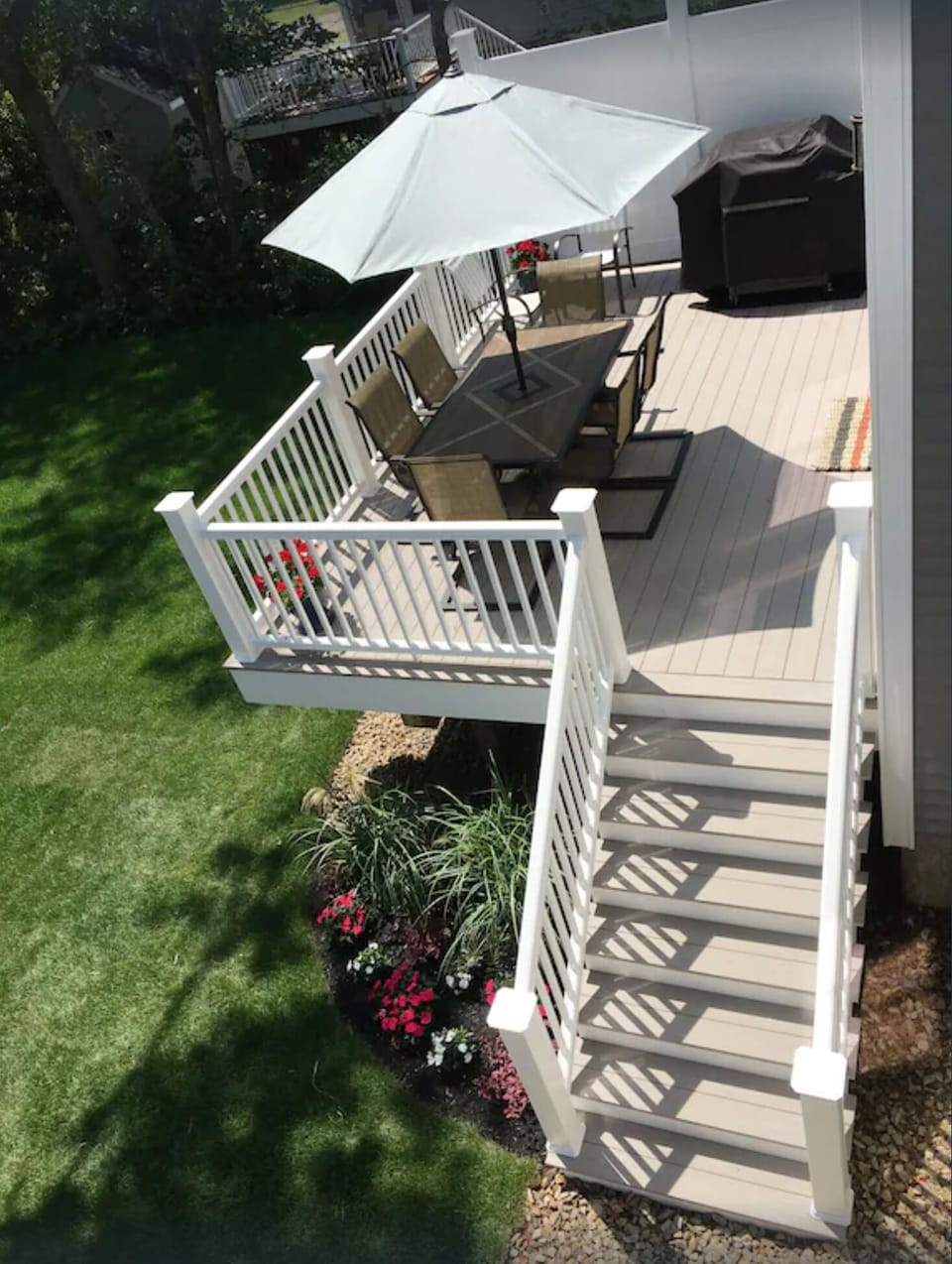 Enjoy the outdoor deck with umbrella table, chairs and gas grill