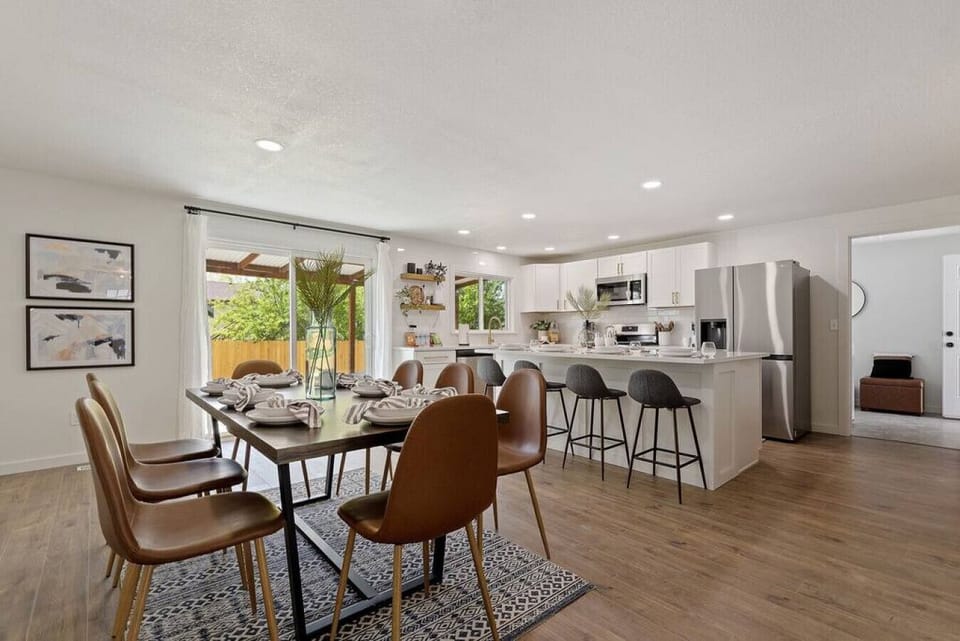 Open layout of the kitchen and dining area with a sliding door leading to the back patio