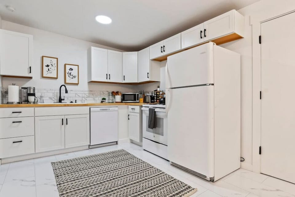 Well-equipped kitchen with a stove, dishwasher, and fridge
