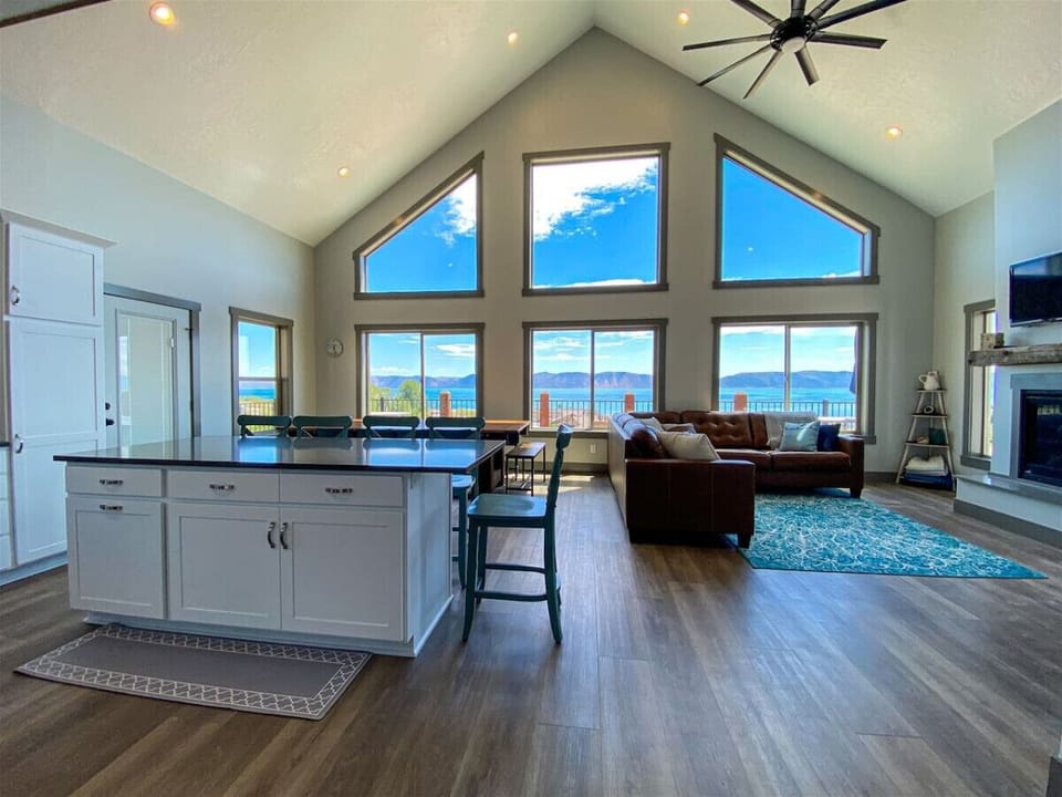 Spacious open-concept living with panoramic lake views and cozy seating for unforgettable gatherings.