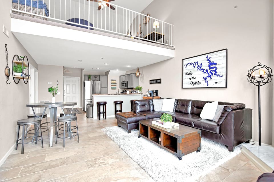 Living room/dining room with leather sectional and table for 4. 