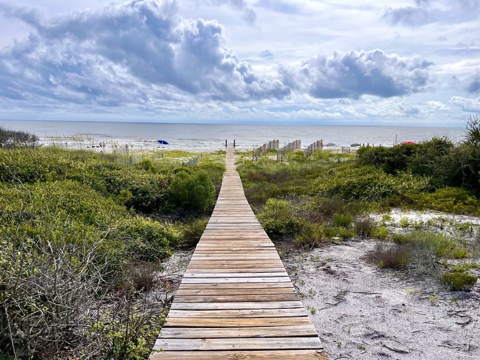 Boardwalk to the beach with a nice slope 3 steps down to the san - Less than a minute walk to the beach