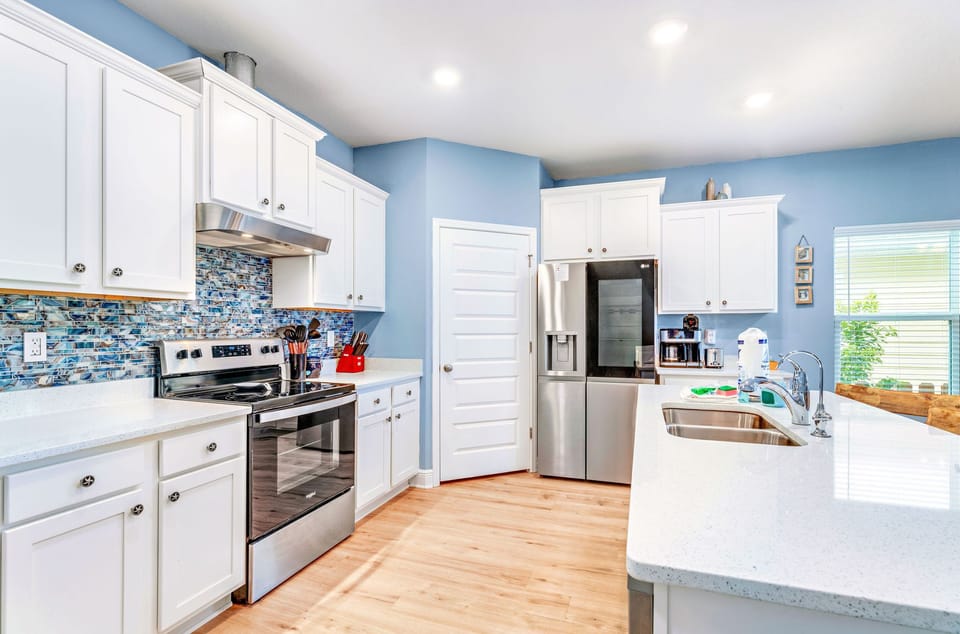 Primary kitchen stocked and equipped with stainless appliances and beautiful granite counters