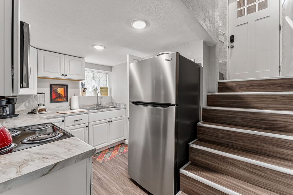 Full kitchen; Stairs shown lead up to the back door entrance
