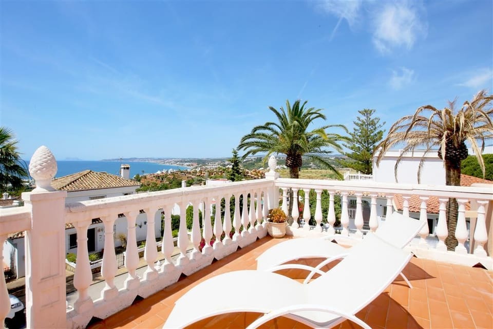 Sunny upper terrace with sun loungers and sea views