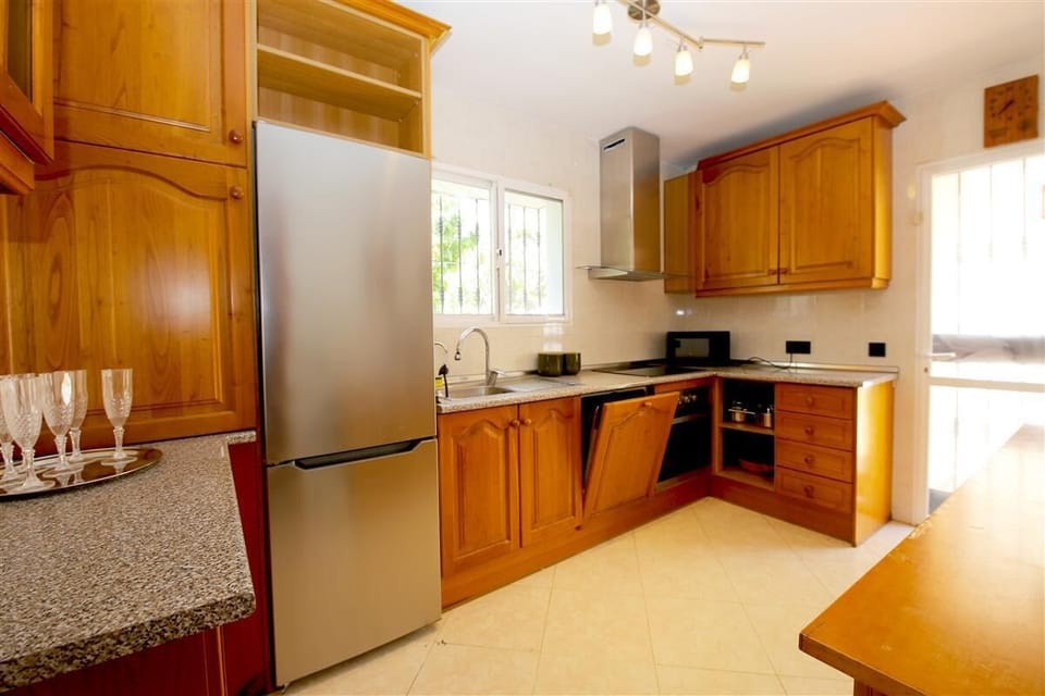 Bright kitchen is fully equipped with all the appliances