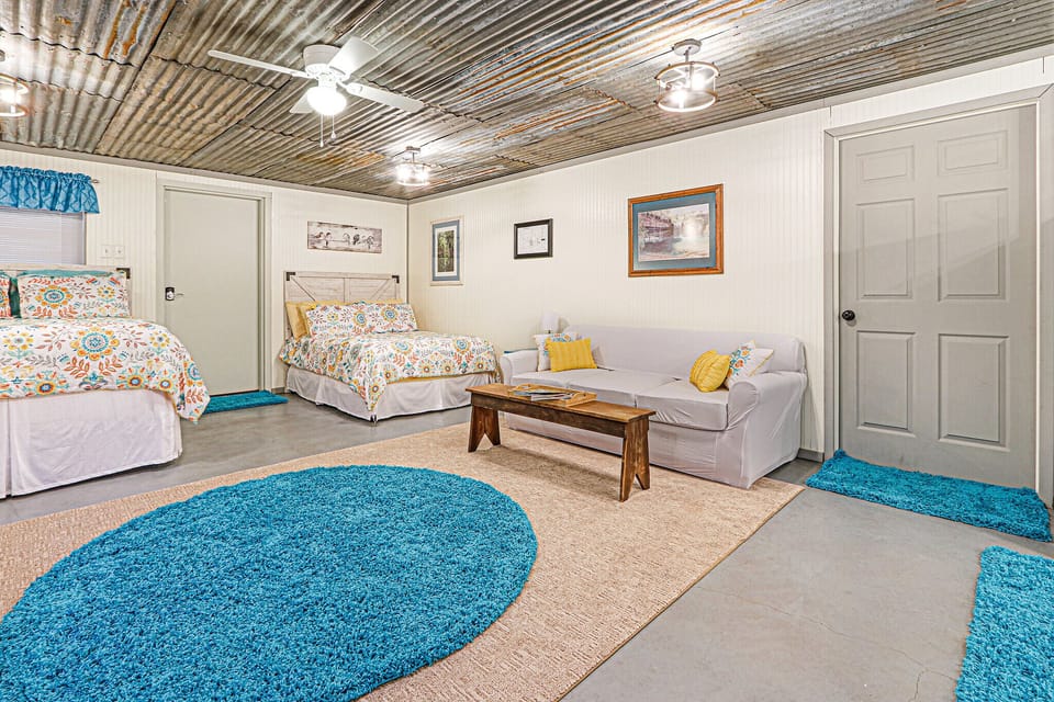 The seating area in front of the full size bed.