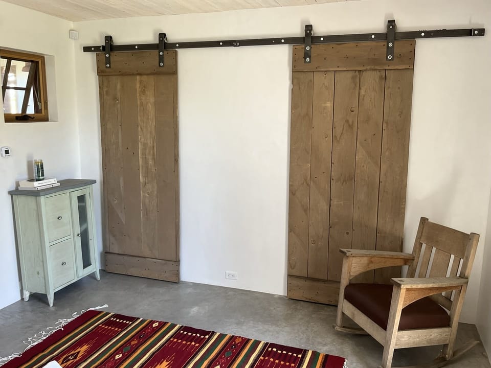 3rd Bedroom has queen bed and sep. entrance. Barn doors mask the bath and closet
