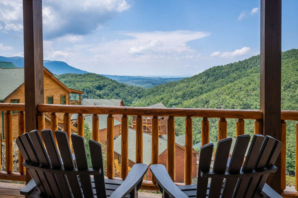 Covered deck with Adirondack chairs and sweeping mountain valley views