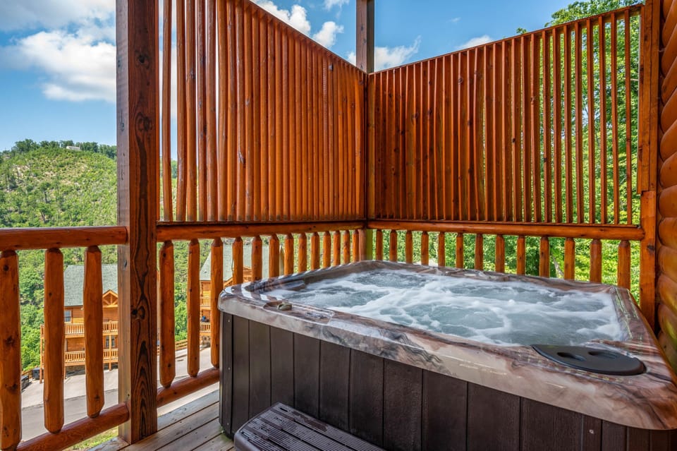 Private hot tub on covered cabin deck with mountain views & privacy.