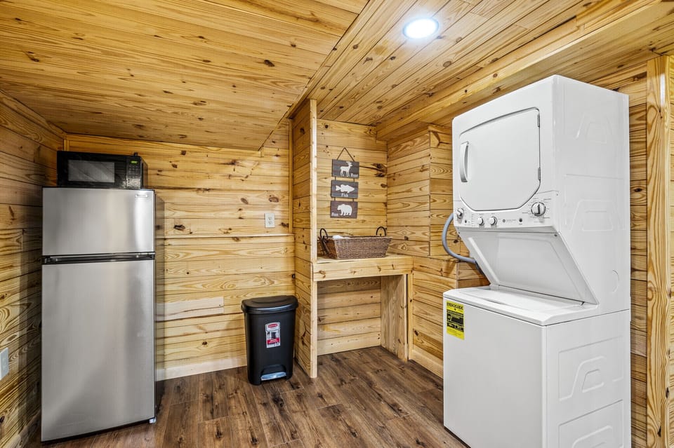 Basement washer and dryer along with fridge and microwave.