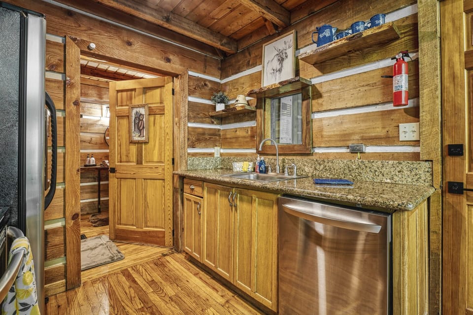 Kitchen with a view out on the nature that encompasses the cabin.