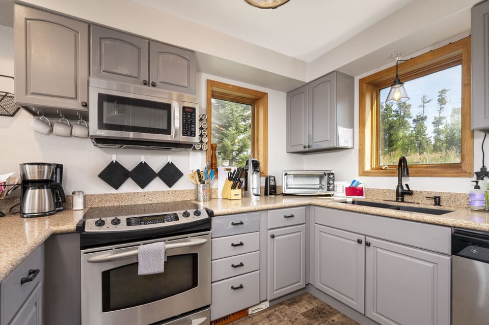 Cozy kitchen with all your culinary needs, with windows bathing the space in natural light