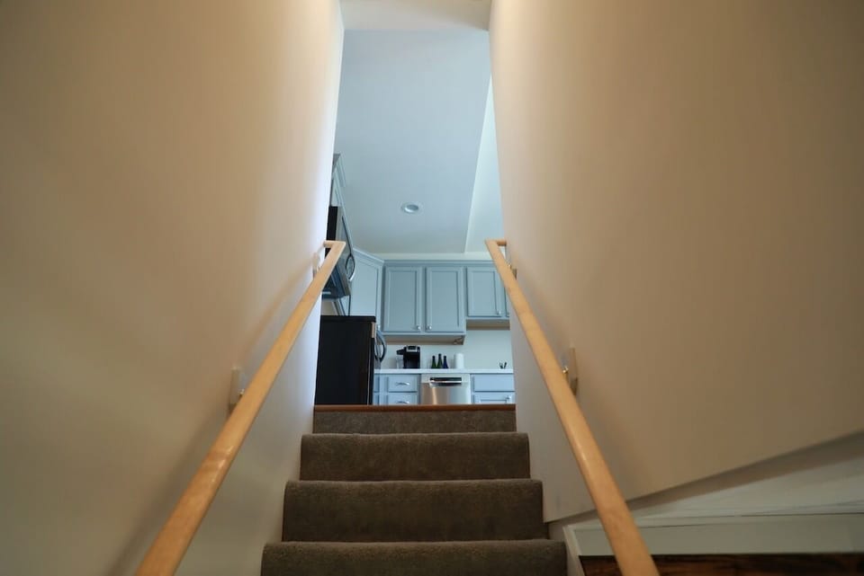 Upstairs is the kitchen, living area, deck, bedroom, and full bath.